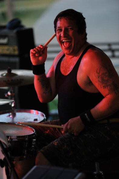 William Rauff, drummer for Live Wire, a tribute band for the hard-rock band AC/DC, performs for Team Incirlik July 10, 2013, at Arkadas Park, Incirlik Air Base, Turkey.  The group performed for two hours to boost the morale of Airmen stationed at the base. The group is one of many entertainment groups chosen by Armed Forces Entertainment to entertain service members stationed overseas. (U.S. Air Force photo by Senior Airman Jarvie Wallace/Released) 