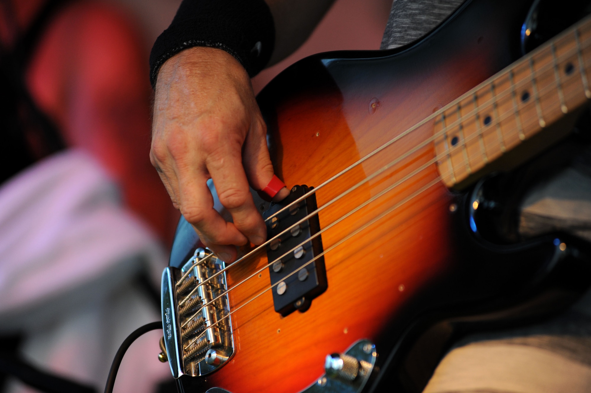 The bass guitarist for Live Wire, a tribute band for the hard-rock band AC/DC, performs for Team Incirlik July 10, 2013, at Arkadas Park , Incirlik Air Base, Turkey. The band gave performances in Turkey and Egypt as part of an Armed Forces Entertainment tour, which provides entertainment for service members, civilians and their families stationed overseas. (U.S. Air Force photo by Senior Airman Jarvie Wallace/Released) 