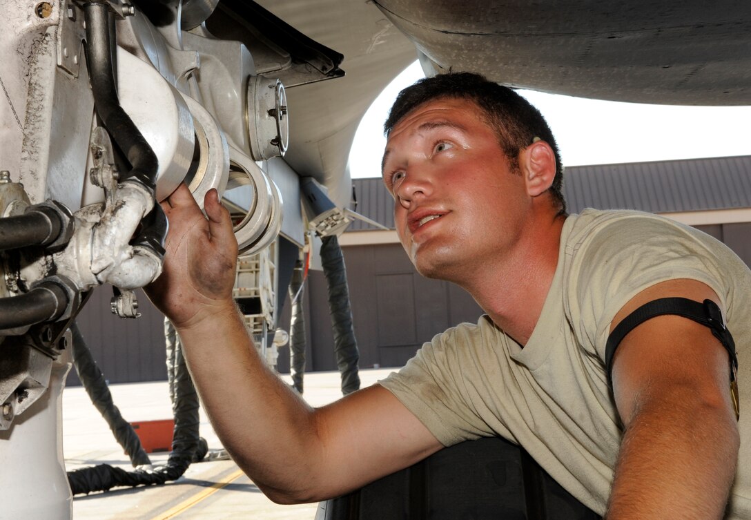 Senior Airman Brandon Wilkins, 28th Aircraft Maintenance Squadron crew chief, inspects a B-1 bomber's landing gear during a Phase II operational readiness exercise on the flightline at Ellsworth Air Force Base, S.D., July 10, 2013.  Aircraft must pass a series of tests, known as a pre-flight inspection, before they can be generated for real-world contingencies or OREs. (U.S. Air Force photo by Airman 1st Class Ashley J. Thum/Released)