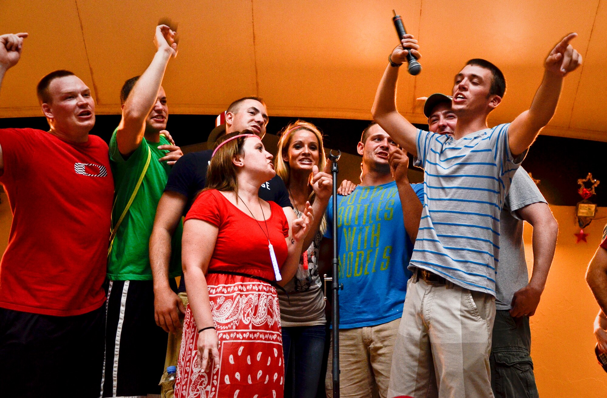 Grand Slam Wing service members rock out with events band, The Ringers, during the July Fourth celebration at the 379th Air Expeditionary Wing in Southwest Asia, July 4, 2013. The Ringers are a wedding and event band on tour from Minneapolis, Minn., and are back by popular request. After the first few songs, 379th AEW service members packed the stage, participated in a dance-off, and hung on every note until the band could play no more. (U.S. Air Force photo/Senior Airman Benjamin Stratton)