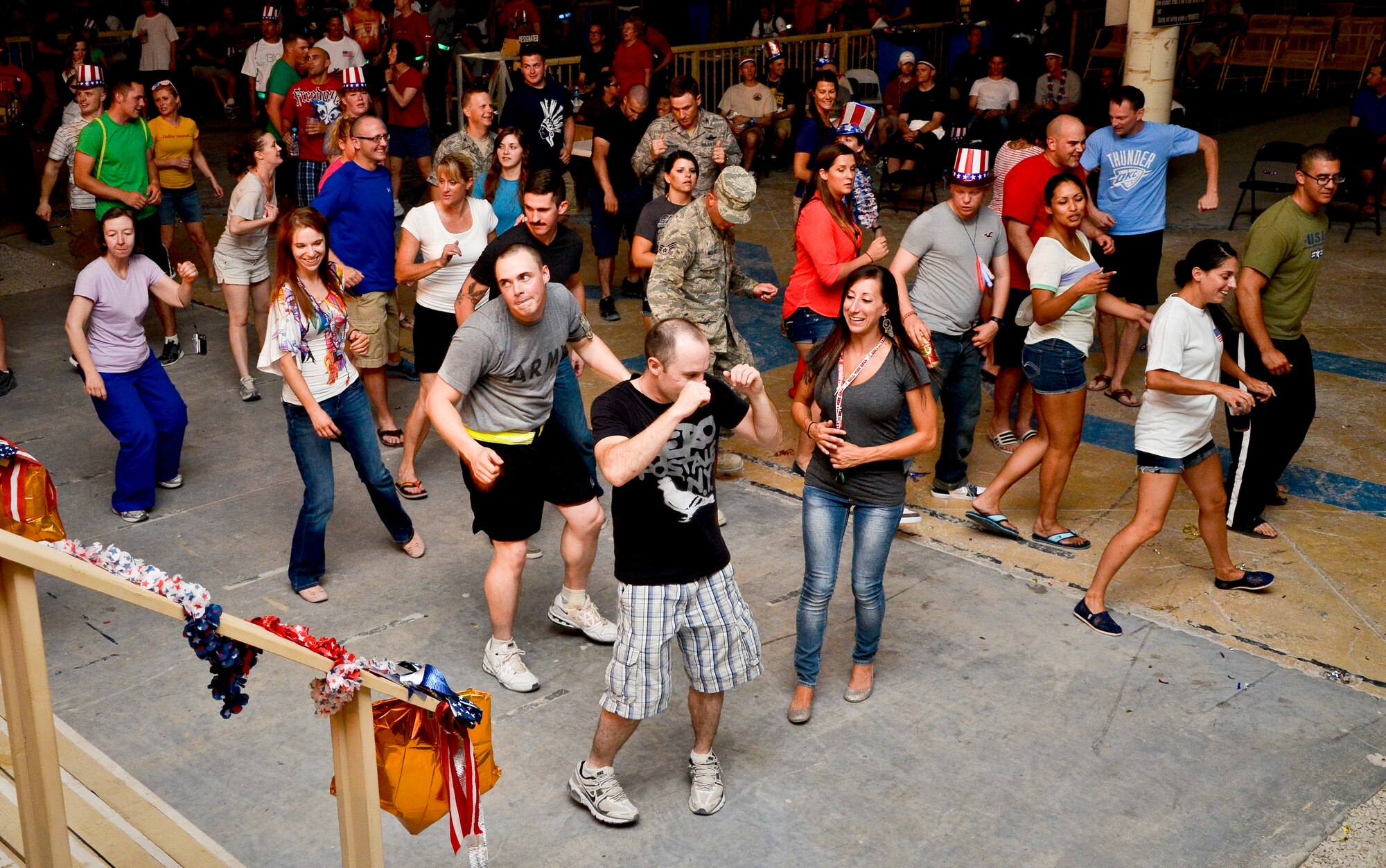 Service members from the 379th Air Expeditionary Wing line dance to the beat of The Ringers during the July Fourth celebration at the 379th AEW in Southwest Asia, July 4, 2013. The Ringers are a wedding and event band on tour from Minneapolis, Minn., and are back by popular request. Grand Slam service members enjoyed music in genres ranging from Rock and Pop to Country and Rhythm and Blues with titles tailored for celebrating America?s freedom. (U.S. Air Force photo/Senior Airman Benjamin Stratton)