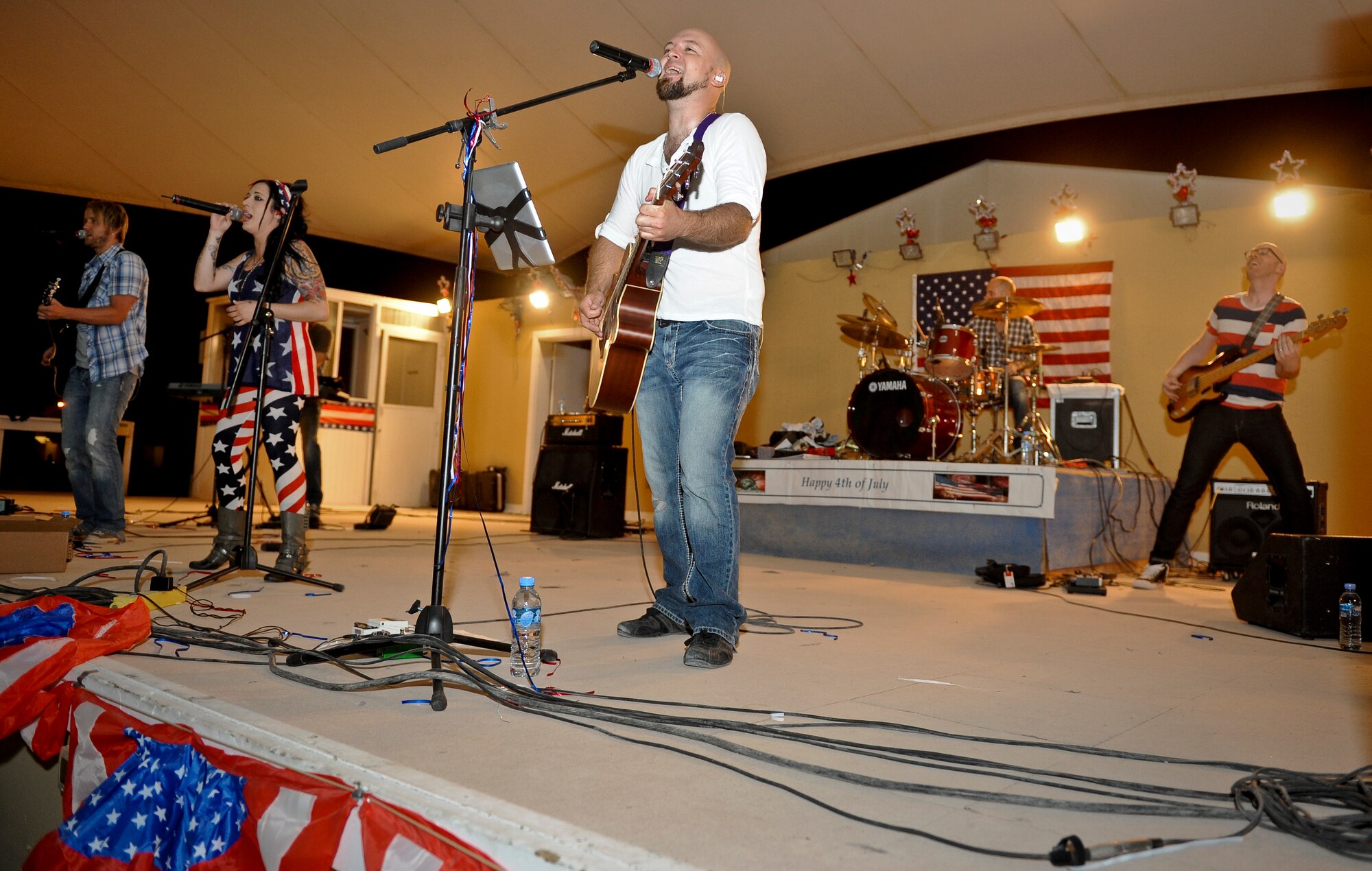 Events band, The Ringers, performs for 379th Air Expeditionary Wing service members during the July Fourth celebration at the 379th AEW in Southwest Asia, July 4, 2013. The Ringers are a wedding and event band on tour from Minneapolis, Minn., and are back by popular request. After the first few songs, 379th AEW service members packed the stage, participated in a dance-off, and hung on every note until the band could play no more. (U.S. Air Force photo/Senior Airman Benjamin Stratton)