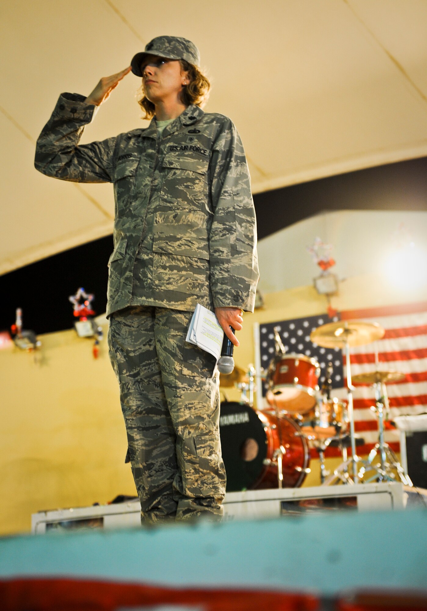 Lt. Col. Sirena Morris salutes as the base honor guard presents the colors during the July Fourth celebration at the 379th Air Expeditionary Wing in Southwest Asia, July 4, 2013. Morris is the 379th Expeditionary Force Support Squadron commander. (U.S. Air Force photo/Senior Airman Benjamin Stratton)