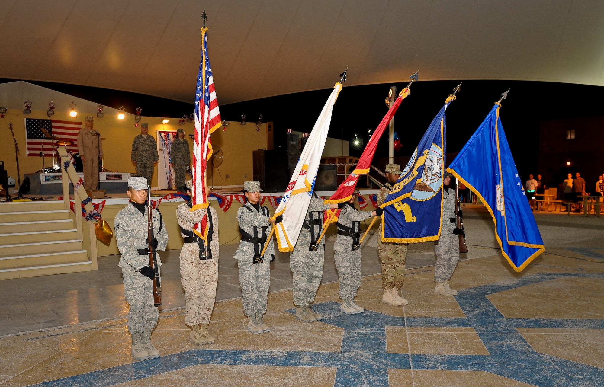 The 379th Air Expeditionary Wing Honor Guard presents the colors during the July Fourth celebration at the 379th AEW in Southwest Asia, July 4, 2013. Service members interested in joining the Honor Guard should call 437-4023. (U.S. Air Force photo/Senior Airman Benjamin Stratton)