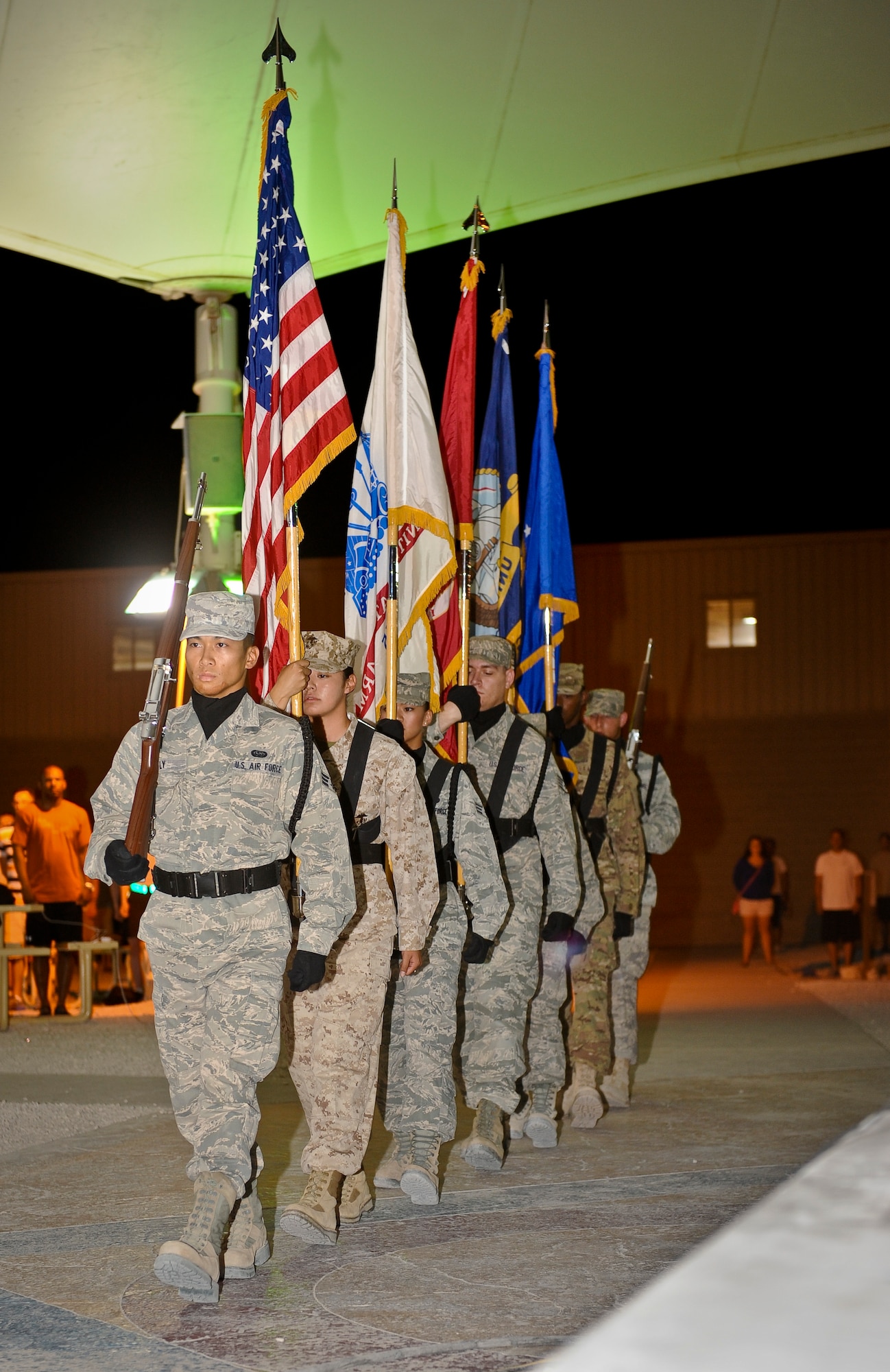 The 379th Air Expeditionary Wing Honor Guard presents the colors during the July Fourth celebration at the 379th AEW in Southwest Asia, July 4, 2013. Service members interested in joining the Honor Guard should call 437-4023. (U.S. Air Force photo/Senior Airman Benjamin Stratton)