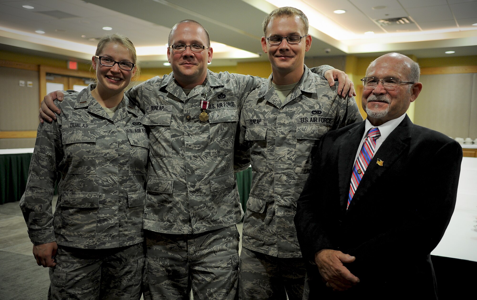 Second Lt. Sarah Dunlap, Senior Master Sgt. Toby Dunlap, Senior Airman Caleb Dunlap, and retired Master Sgt. James Dunlap come together for a group photo at Osan Air Base, Republic of Korea, June 28, 2013. A member of the Dunlap family has been serving in the Air Force every day since its inception in 1947. Sarah is an architectural engineer assigned to the 7th Civil Engineer Squadron at Dyess Air Force Base, Texas; Toby is the 7th Air Force chemical, biological, radiological, and nuclear defense manager at Osan; and Caleb is a flight line maintenance crew member assigned to the 51st Maintenance Squadron at Osan. (U.S. Air Force photo/Staff Sgt. Sara Csurilla)