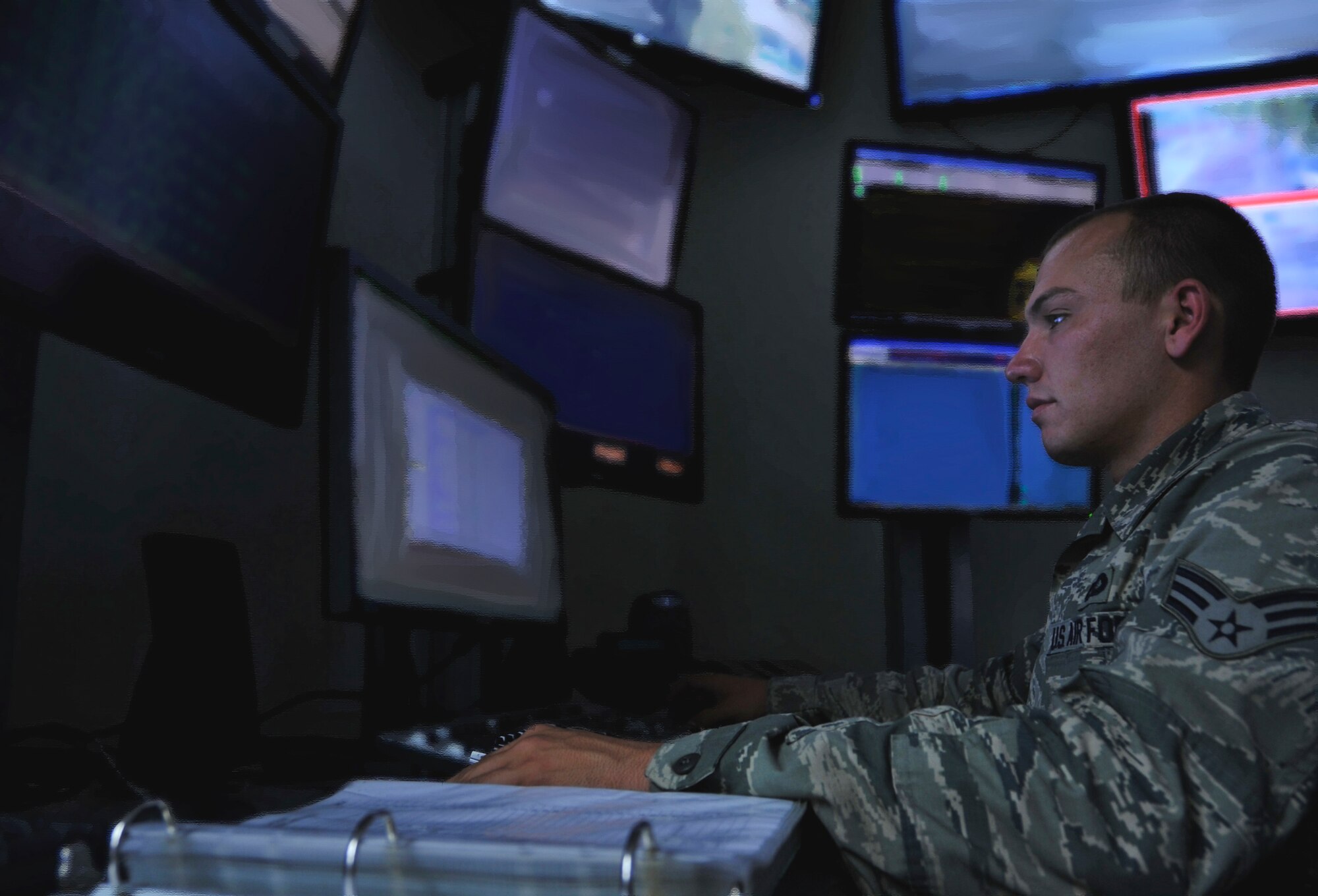 Senior Airman Zachary Johnston, 51st Security Forces Squadron tactical automated security system operator, monitors the base alarms and surveillance systems in the Combined Defense Operations Center on Osan Air Base, Republic of Korea, June 27, 2013. CDOC monitors more than 180 cameras on base, safeguarding $54 billion of assets on Osan. (U.S. Air Force photo/Senior Airman Kristina Overton)