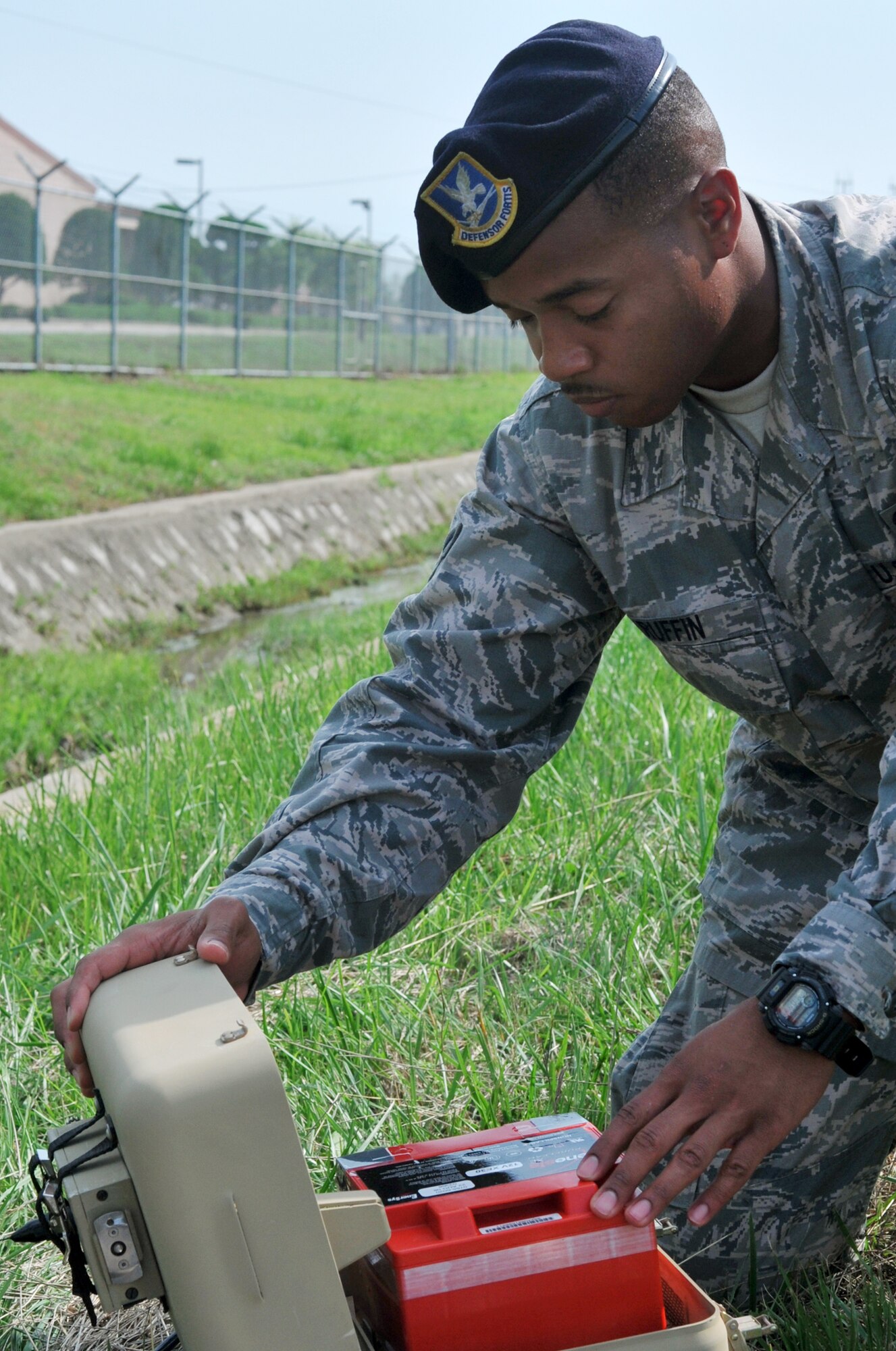 Airman 1st Class Taali Ruffin, 51st Security Forces Squadron tactical automated security system administrator, inspects the rechargeable battery module of a passive infrared sensor during a regular maintenance inspection on Osan Air Base, Republic of Korea, June 27, 2013. Airmen working electronic security monitor sensor system malfunctions and upgrades, and are in charge of alarms and more than 180 cameras, ensuring each system is 100 percent intruder detection capable. (U.S. Air Force photo/Senior Airman Kristina Overton) 