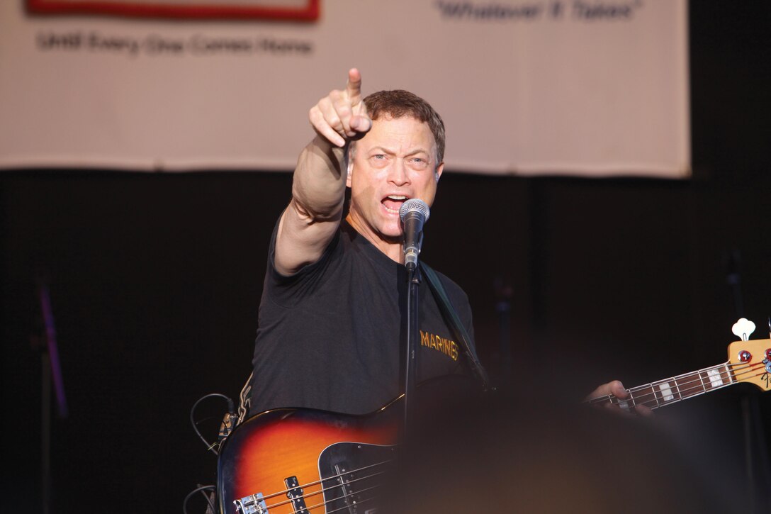 Gary Sinise sings during the Lt. Dan Band’s performance July 6 at Marine Corps Air Station Futenma. The band played covers of songs ranging from classic hits to current chart-toppers. Sinise is the bassist for the band. Photo by Lance Cpl. Natalie M. Rostran