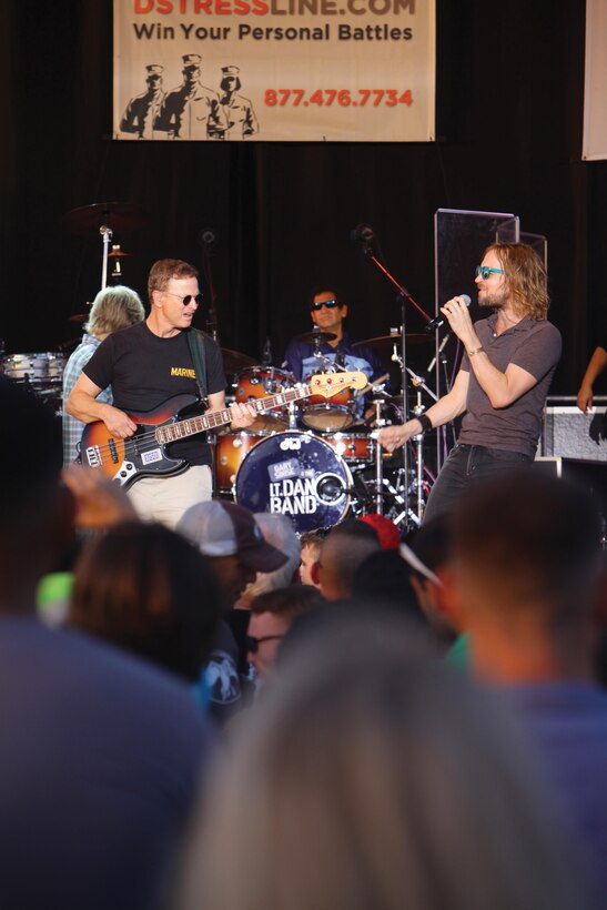 Gary Sinise, left, and Dan Myers perform a song during the Lt. Dan Band’s performance July 6 at Marine Corps Air Station Futenma. The concert was part of a tour that visited several U.S. bases throughout Japan and was sponsored by the USO and TriWest Healthcare Alliance. Sinise is the band’s bassist, and Myers is the vocalist and violinist. Photo by Lance Cpl. Natalie M. Rostran