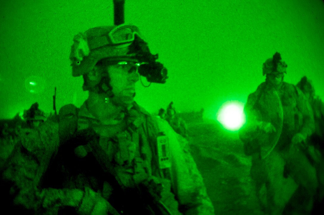As seen through a night-vision device, U.S. Marines conduct mission rehearsals on Camp Leatherneck in Afghanistan's Helmand province, July 10, 2013. The Marines, assigned to Golf Company, 2nd Battalion, 8th Marine Regiment, trained to maintain operational readiness and efficiency.