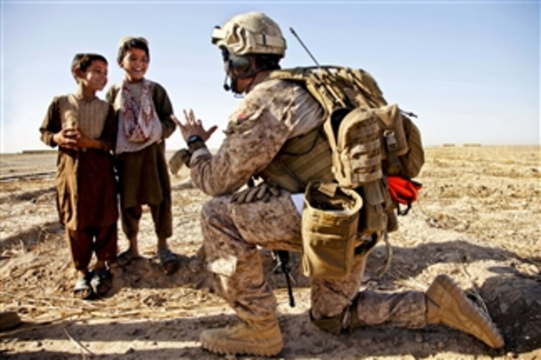 U.S. Marine Corps Capt. Bob J. Sise interacts with Afghan children during Operation Northern Lion II in the Helmand province of Afghanistan on July 3, 2013.  Northern Lion II is a Georgian-led operation conducted to deter insurgents, establish a presence, and gather human intelligence in the area.  Sise is assigned to Georgian Liaison Team-9
