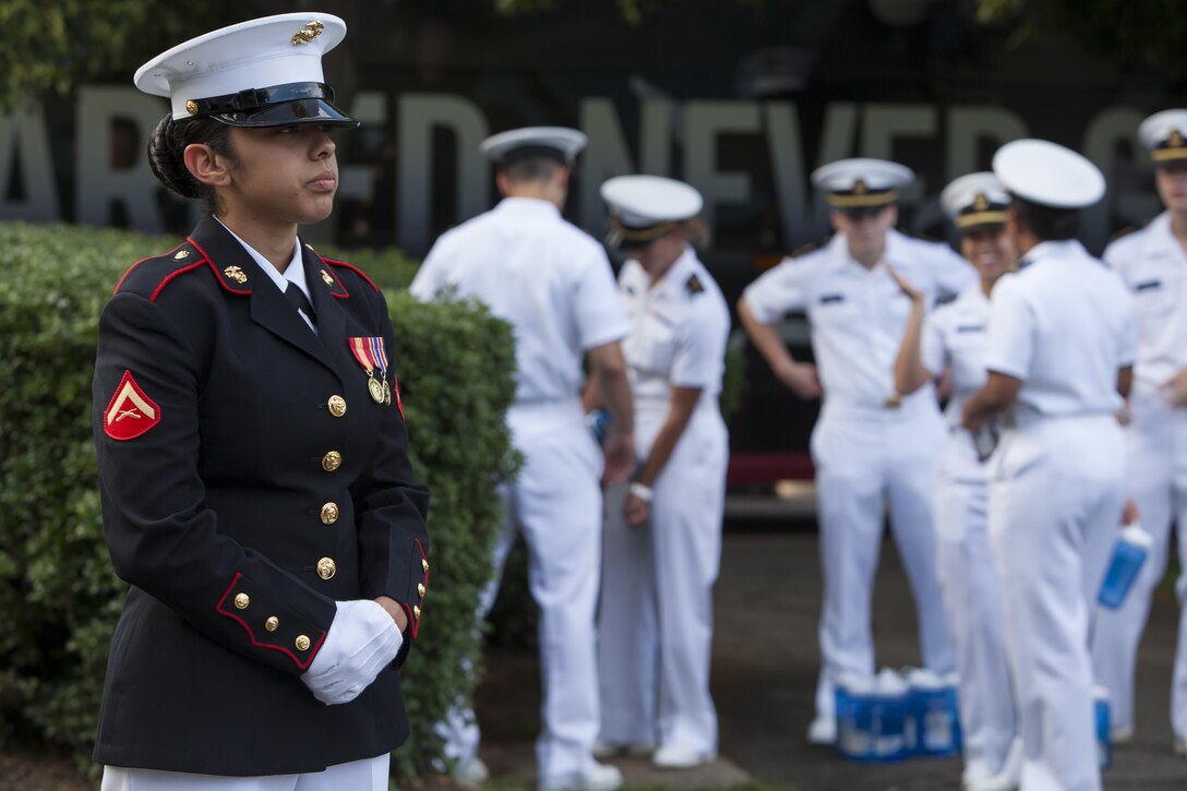 Lance Cpl. Daniela Gonzalez, a ceremonial hoster with Marine Barracks Washington, D.C., stands her post prior to the commencement of a Tuesday Sunset Parade at the Marine Corps War Memorial in Arlington, Va., June 11. 