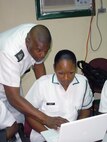 Royal Bahamas Defence Force Petty Officer Maxwell Lloyd, RBDF Public Relations, assists RBDF Leading Woman Marine Karen Bastian, RBDF Information and Technology, with a Social Media application during an information exchange hosted by Headquarters North American Aerospace Defense Command and U.S. Northern Command Public Affairs at Coral Harbour, The Bahamas July 27-28. The two-day exchange demonstrated how NORAD and U.S. NORTHCOM currently uses Social Media as a public affairs tool and different ways this platform can streamline public affairs activities. 

