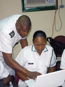 Royal Bahamas Defence Force Petty Officer Maxwell Lloyd, RBDF Public Relations, assists RBDF Leading Woman Marine Karen Bastian, RBDF Information and Technology, with a Social Media application during an information exchange hosted by Headquarters North American Aerospace Defense Command and U.S. Northern Command Public Affairs at Coral Harbour, The Bahamas July 27-28. The two-day exchange demonstrated how NORAD and U.S. NORTHCOM currently uses Social Media as a public affairs tool and different ways this platform can streamline public affairs activities. 

