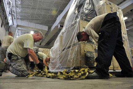 Airmen from the 621st Contingency Response Wing at Joint Base McGuire-Dix-Lakehurst, N.J., prepare emergency equipment for immediate response to Hurricane Irene at the CRW’s Global Reach Deployment Center here Aug. 25. The roughly 600 Airmen of the CRW specialize in creating aerial port and command-and-control facilities in damaged or hostile environments. Previous missions have included humanitarian responses to Haiti, Pakistan and Japan in the aftermath of earthquakes, floods and tsunami in addition to Hurricanes Ike, Rita, Gustav and Katrina. (U.S. Air Force photo/Tech. Sgt. Parker Gyokeres) (released)