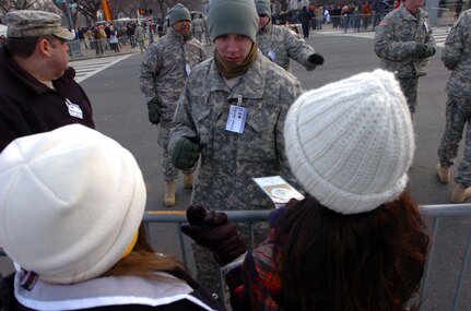 Pvt. 2nd Class David Niedlinger, a fire support specialist with Headquarters and Headquarters Troop, 1st Squadron, 158th Cavalry Regiment, Maryland National Guard, gives directions to lost spectators before inauguration ceremonies for President Elect Barack Obama, Tuesday, Jan. 20. The unit, a part of the 58th Infantry Brigade Combat Team, assisted U.S. Park Police, Secret Service, and other federal agencies with crowd management.