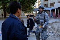 Chaplain (Capt.) Kelvin Francis, 732nd Air Expeditionary Group Religious Support Team, currently deployed from Shaw Air Force Base, S.C., while on foot-patrol in a apartment complex in Baghdad, Iraq, International Zone on Jan. 10, entertains Iraqi children by juggling balls. Francis is a native of Jacksonville, Fla.