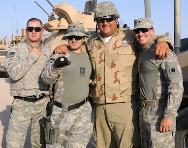 Tony Siragusa, second from right, former National Football League player and co-host of DIY Network TV's "Man Caves," bonds with members of an Ohio National Guard unit during a taping of the show's one-hour special, "Man Caves: USO Troop Edition."