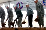 Lt. Gen. Clyde Vaughn, in fleece jacket, director of the Army National Guard; Pvt. Megan Jones, a student in the GED Plus program; and Maj. Gen. William D. Wofford, right, adjutant general for Arkansas, perform ceremonial groundbreaking honors for new facilities for the GED Plus program, Sunday, Jan. 25, 2009. The GED Plus program allows non-high school graduates to enlist in the Army National Guard with the stipulation they earn their GED prior to attending Basic Combat Training. In order to reach that goal, those in the program attend a course at the Army National Guard's Professional Education Center at Camp Robinson that prepares them to complete the GED exam.