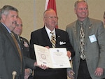 Mark Light, left, executive director of the International Association of Fire Chiefs, Thomas F. Hall, center, assistant secretary of defense for reserve affairs, and Larry Grorud, the fire chief association's president, display an Employer Support of the Guard and Reserve statement of support signed on the association's behalf Jan. 23, 2009, in Washington, D.C.