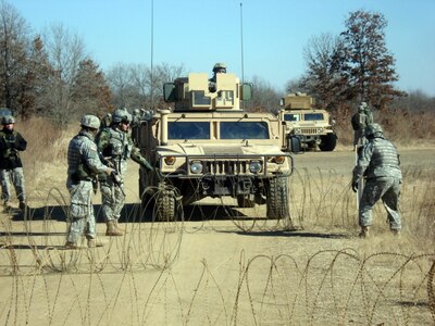 Soldiers from the 1st Battalion, 147th Field Artillery, set up a hasty check point during the annual training period at Fort Chaffe, Ark., Jan. 10-24. 