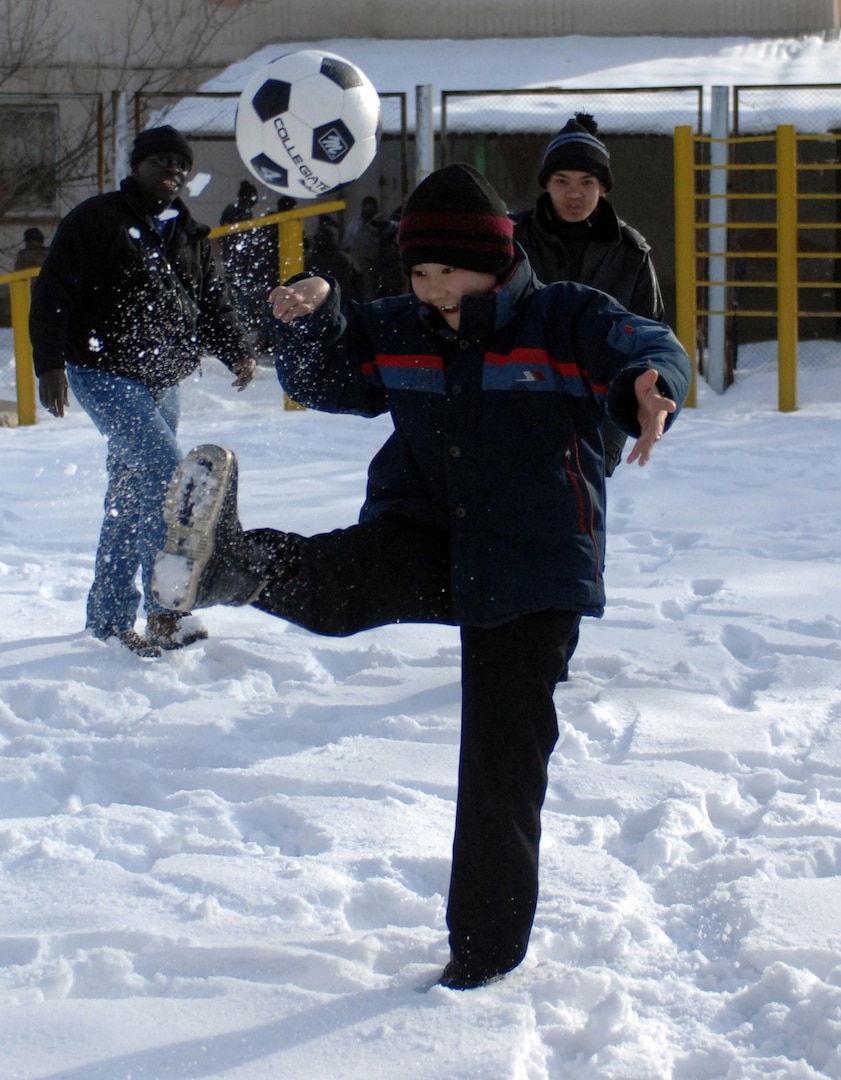 A young boy shows off his soccer skills to Staff Sgt. Milbert Bourgeois and another friend at the Belovodsk, or Belovodosky orphanage, north of Bishkek, Kyrgyzstan. Airmen from nearby Manas Air Base visit the orphanage frequently to share friendship and donated toys, as well as clothing, blankets, diapers and toiletries. There are more than 265 disabled children in the orphanage between the ages of 4 and 18. Bourgeois is a Nevada Air National Guardsman who is deployed with the 376th Expeditionary Security Forces Squadron.