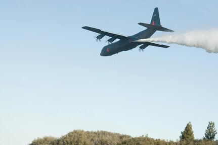 A California Air National Guard C-130J Hercules cargo aircraft from the 146th Airlift Wing releases water in a test of a new Modular Airborne Fire Fighting System (MAFFS) system in late January. The 146th was the first unit to be approved for use of the new MAFFS II system.