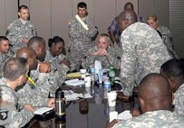 Col. David Wilcox (center), the chief of staff for U.S. Army North’s Contingency Command Post, listens as his staff briefs him Aug. 26 as the team prepares for the imminent arrival of Hurricane Irene to the East Coast of the United States. The members of the contingency command post prepare to deploy forward to Joint Base McGuire-Dix-Lakehurst, N.J., in anticipation of requests for assistance from the Federal Emergency Management Agency, which is the overall lead for the federal response effort for Hurricane Irene. 

