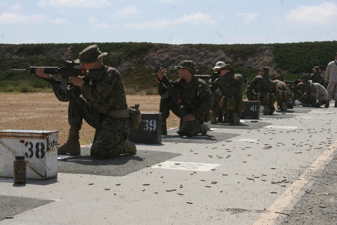 Recruits of Company D, 1st Recruit Training Battalion, shoot from the kneeling position during qualification week at Edson Range aboard Marine Corps Base Camp Pendleton June 25. There are four positions recruits must master--the prone, the sitting, standing and kneeling. 