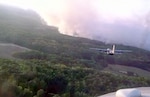 A Modular Airborne Firefighting System-equipped C-130 Hercules prepares for a fire retardant run over a wildfire Sept. 12 in Harrison County, Texas. Four MAFFS C-130 aircraft, assigned to the 302nd Air Expeditionary Group based at Austin-Bergstrom International Airport in Austin, Texas, provided approximately 12,000 gallons of retardant to two fires in the northeast Texas county. 

