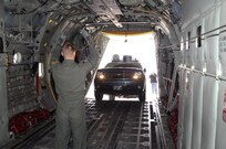 Airman 1st Class Richie Meyer, 39th Airlift Squadron loadmaster, guides the NORAD and USNORTHCOM Emergency Response Vehicle into the back of a C-130J aircraft in preparation for a flight to a disaster response exercise in Montana May 5. The customized 2010 Chevrolet Suburban sports an advanced communications package that provides U.S. Northern Command with phone communications, secured computer networks, commercial internet and video teleconferencing in a mobile package small enough to be transported by a C-130. This is the first time the ERV is being airlifted to a site in support of an exercise. 

