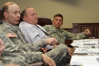 Gen. Charles Jacoby, Jr. (left), commanding general, North American Aerospace Defense Command and U.S. Northern Command, Robert Fenton Jr. (center), assistant administrator, Federal Emergency Management Agency, and Lt. Gen. William Caldwell IV, commanding general, U.S. Army North (Fifty Army) discuss the importance of preparation for any eventuality during the Complex Catastrophe Tabletop Exercise held June 5 at Army North in the historic Quadrangle. 

