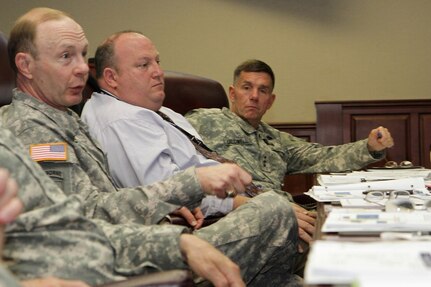 Gen. Charles Jacoby, Jr. (left), commanding general, North American Aerospace Defense Command and U.S. Northern Command, Robert Fenton Jr. (center), assistant administrator, Federal Emergency Management Agency, and Lt. Gen. William Caldwell IV, commanding general, U.S. Army North (Fifty Army) discuss the importance of preparation for any eventuality during the Complex Catastrophe Tabletop Exercise held June 5 at Army North in the historic Quadrangle. 

