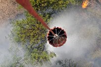 U.S. Army pilots and crew members with the 2nd General Support Aviation Battalion, 4th Aviation Regiment, 4th Combat Aviation Brigade, 4th Infantry Division, release water with a helicopter bucket over fires during a firefighting mission at Black Forest, Colo., June 12, 2013. 

