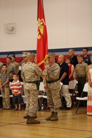 Lt. Col. Matthew A. Dumenigo takes command of Combat Logistics Battalion 24, Combat Logistics Regiment 27, 2nd Marine Logistics Group from Lt. Col. Daniel J. Bradley during a ceremony aboard Camp Lejeune, N.C., July 12, 2013.  Dumenigo previously served as the executive officer of CLR-27. (U.S. Marine Corps photo by Lance Cpl. Shawn Valosin)