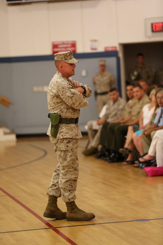 Lt. Col. Daniel J. Bradley, the outgoing commanding officer of Combat Logistics Battalion 24, Combat Logistics Regiment 27, 2nd Marine Logistics Group, addresses a crowd of fellow service members and loved ones during a change of command ceremony aboard Camp Lejeune, N.C., July 12, 2013. Bradley relinquished command to Lt. Col. Matthew A. Dumenigo, and was scheduled to retire after serving for 25 years. (U.S. Marine Corps photo by Lance Cpl. Shawn Valosin)