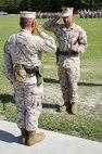 First Sgt. Monroe C. Boykin (right), the outgoing sergeant major 8th Engineer Support Battalion, 2nd Marine Logistics Group salutes Lt. Col. Ferdinand F. Llantero (left), during a relief and appointment ceremony held aboard Camp Lejeune, N.C., July 11, 2013. Boykin turned the battalion sergeant major’s Sword of Officer over to Sgt. Maj. Russell A. Strack. 