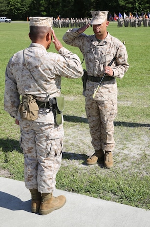 First Sgt. Monroe C. Boykin (right), the outgoing sergeant major 8th Engineer Support Battalion, 2nd Marine Logistics Group salutes Lt. Col. Ferdinand F. Llantero (left), during a relief and appointment ceremony held aboard Camp Lejeune, N.C., July 11, 2013. Boykin turned the battalion sergeant major’s Sword of Officer over to Sgt. Maj. Russell A. Strack. 