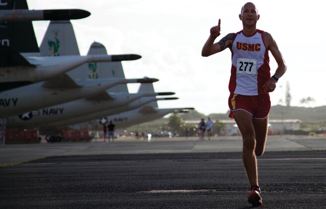 Tyler Hubbard, sprints to the finish line at Hangar 104 for the base's annual Runway Run 5k, July 4, 2013. Hubbard came in first place. (U.S. Marine Corps photo by Lance Cpl. Janelle Y. Chapman)