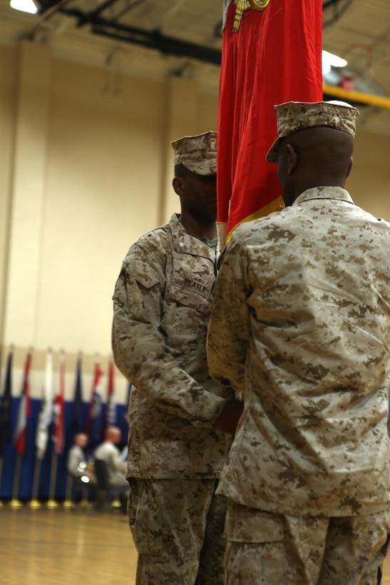 CAMP GEIGER, N.C. -  Lt. Col. Ricardo T. Player, School of Infantry-East Headquarters and Support Battalion oncoming commanding officer, receives the battalion's colors from the off-going commanding officer, Lt. Col. Stacey L. Taylor during a change of command ceremony at the Camp Geiger Fitness Center aboard Camp Geiger, a satellite installation of Marine Corps Base Camp Lejeune, June 28. Taylor and Player both attended Kappa Alpha Psi fraternity, following the footsteps of Capt. Fredrick C. Branch, the first African American Marine Corps commissioned officer. "It is my duty to provide the leadership so that H&S Battalion Marines are taken care of in order to accomplish their mission," said Player. "I'm humble, excited and motivated. It's truly an honor to lead this great battalion."