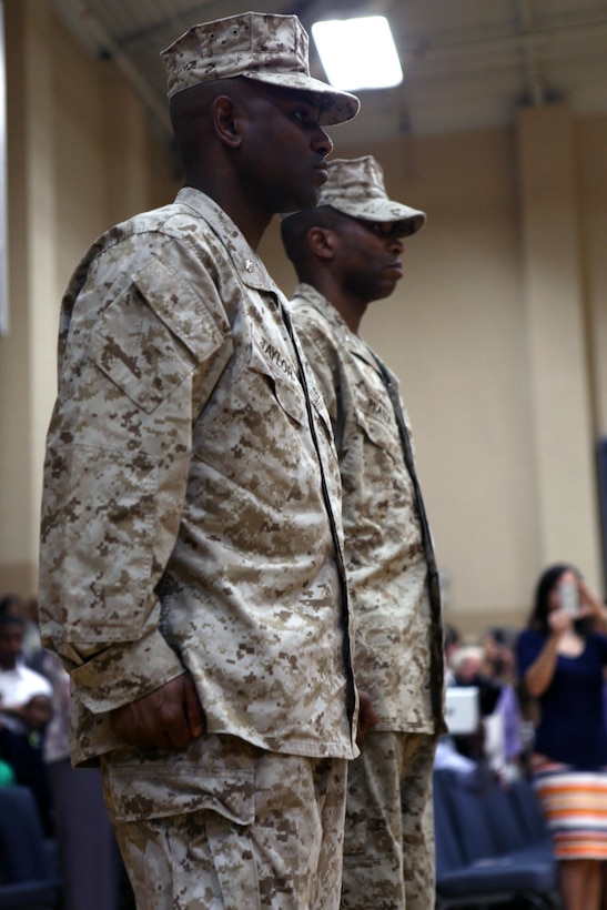 CAMP GEIGER, N.C. - Lt. Col. Stacey L. Taylor, School of Infantry-East Headquarters and Support Battalion outgoing commanding officer, stands next to Lt. Col. Ricardo T. Player, School of Infantry-East Headquarters and Support Battalion oncoming commanding officer, during a change of command ceremony at the Camp Geiger Fitness Center aboard Camp Geiger, a satellite installation of Marine Corps Base Camp Lejeune, June 28. Taylor and Player both attended Kappa Alpha Psi fraternity, following the footsteps of Capt. Fredrick C. Branch, the first African American Marine Corps commissioned officer. "It is my duty to provide the leadership so that H&S Battalion Marines are taken care of in order to accomplish their mission," said Player. "I'm humble, excited and motivated. It's truly an honor to lead this great battalion."