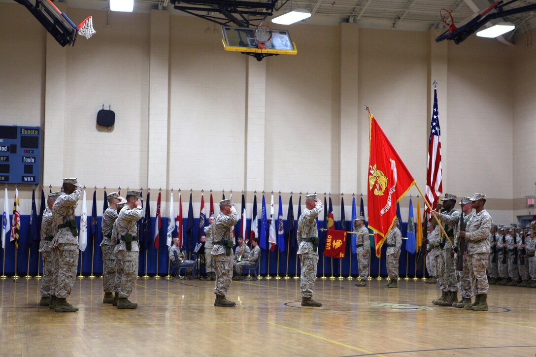 CAMP GEIGER, N.C. - School of Infantry-East Headquarters and Support Battalion Marines salute the American Flag while the National Anthem plays during a change of command ceremony at the Camp Geiger Fitness Center aboard Camp Geiger, a satellite installation of Marine Corps Base Camp Lejeune, June 28. Lt. Col. Stacey L. Taylor, School of Infantry-East Headquarters and Support Battalion outgoing commanding officer, handed the reins of the battalion to Lt. Col. Ricardo T. Player, School of Infantry-East Headquarters and Support Battalion oncoming commanding officer. Taylor and Player both attended Kappa Alpha Psi fraternity, following the footsteps of Capt. Fredrick C. Branch, the first African American Marine Corps commissioned officer. "It is my duty to provide the leadership so that H&S Battalion Marines are taken care of in order to accomplish their mission," said Player. "I'm humble, excited and motivated. It's truly an honor to lead this great battalion."