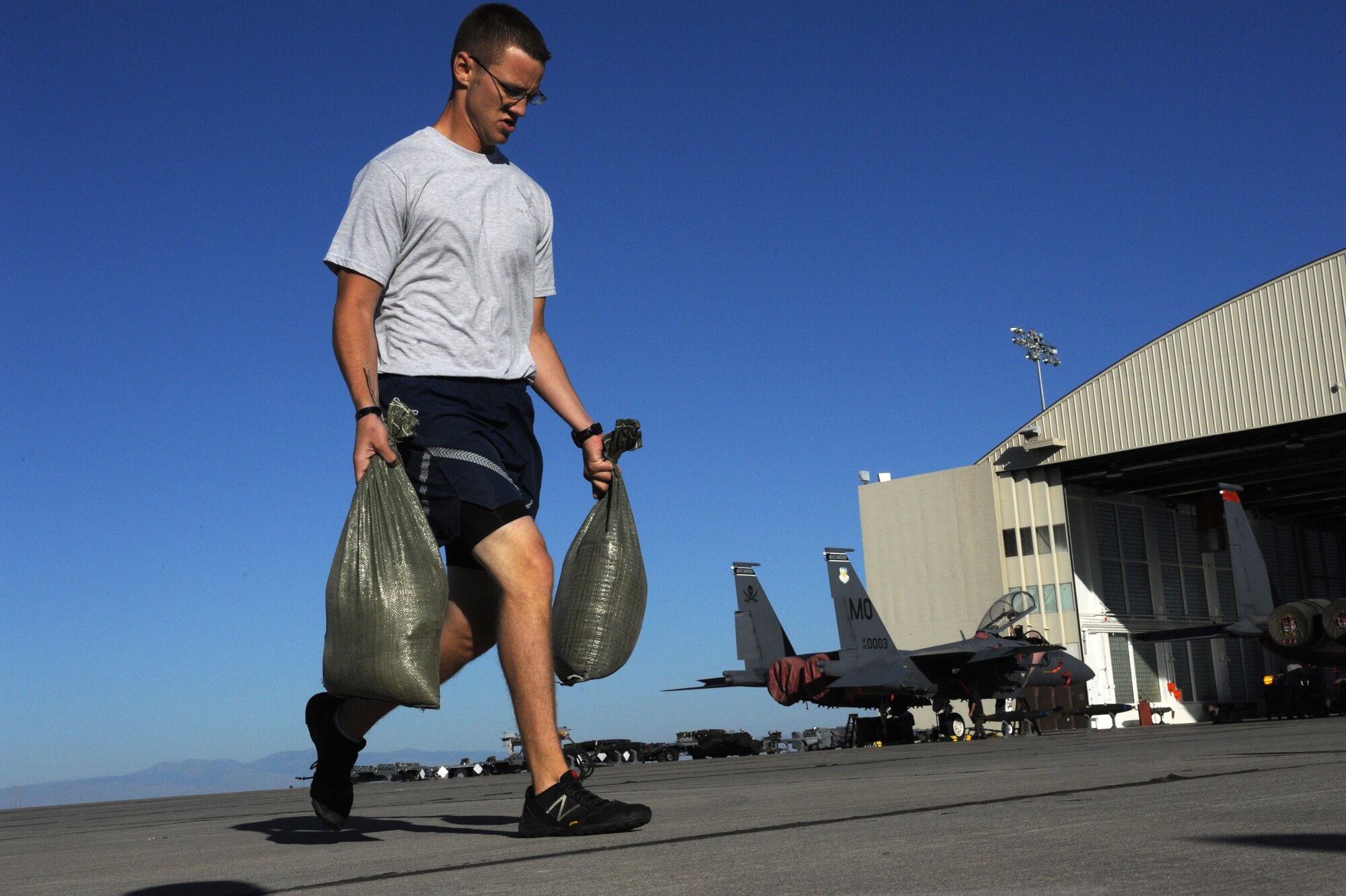 An Airman races through the sandbag portion of the Gunfighter Challenge July 12, 2013, at Mountain Home Air Force Base, Idaho. The event was part of the timed relay challenging personnel from the 366th Maintenance Group. (U.S. Air Force photo by Senior Airman Benjamin Sutton/ Released)