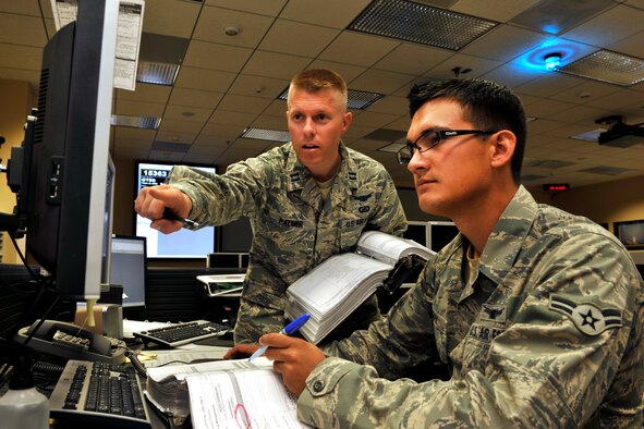 Capt. Eric Palmer and Airman 1st Class Quillan Fay, 1st Space Operations Squadron, review Operationally Responsive Space-1 procedures and mission objectives in preparation for a satellite contact here June 29. The squadron celebrated the two-year anniversary of ORS-1's launch with a low-key ceremony hours later. (U.S. Air Force photo/Dennis Rogers)