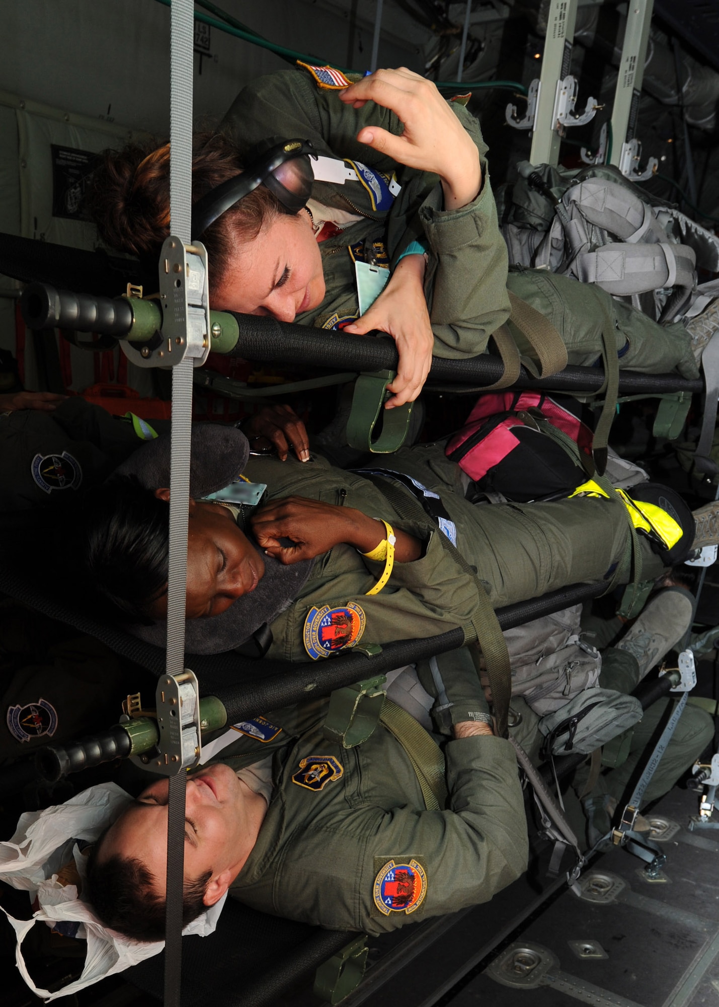 Aeromedical evacuation technicians with the 43rd AES play patient during a training flight on a Royal Canadian Air Force C-130J medium transport aircraft at Pope Field, N.C., on July 12, 2013.  During the flight, members of the 43rd AES and 36th AES were shadowed by personnel from the RCAF 426 Squadron Medical Flight while taking part in a two-day training mission intended to enhance inter-service partnership and provide continuation training.  (Air Force Photo by Tech. Sgt. Peter R. Miller)