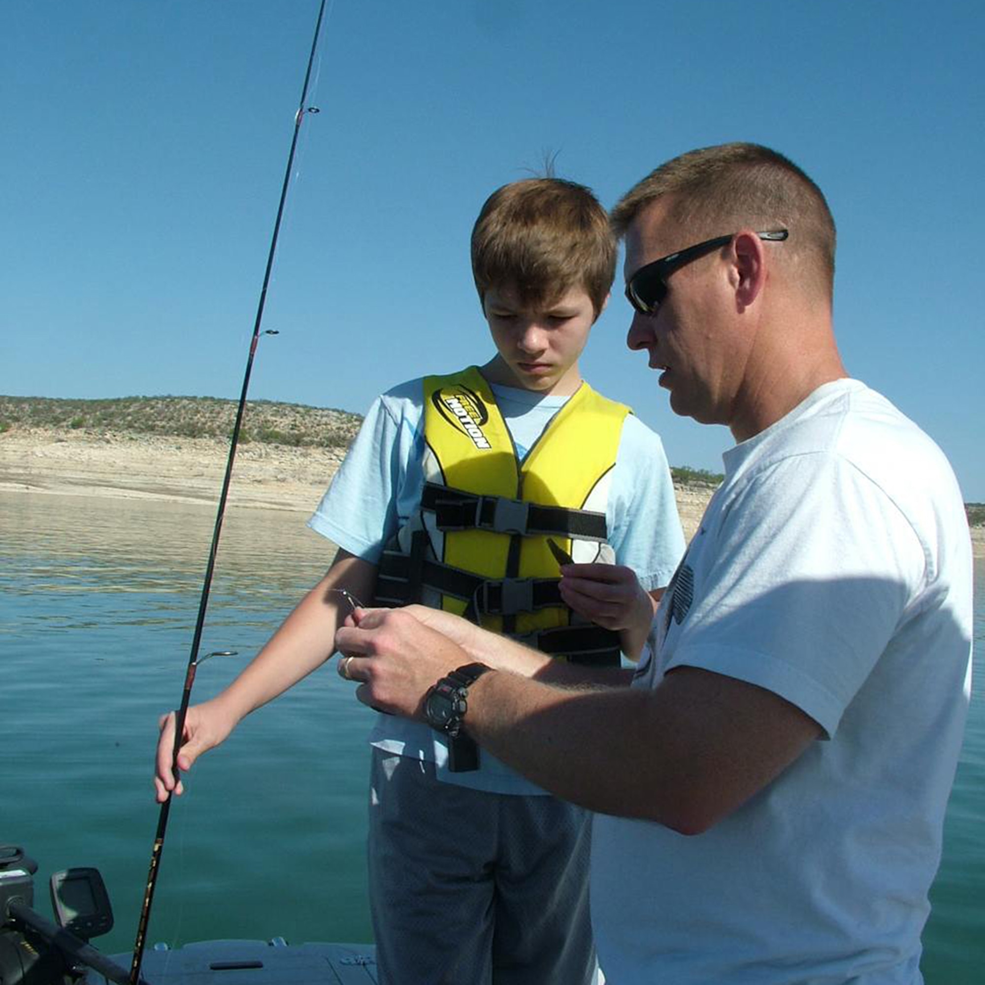 Lt. Col. Errol Rottman Jr. and his 13-year old son, Ryan, ready a pole for a day of fishing. But the lake turned the tables on them when it “snagged” the boat they 
were in. (Courtesy photo)