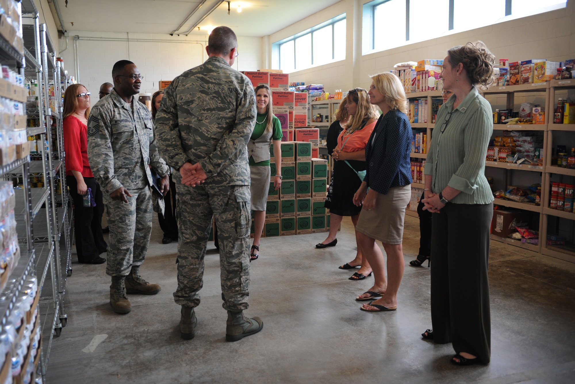 Athena Cody, spouse of Chief Master Sgt. of the Air Force James Cody, tours the first sergeants pantry at Minot Air Force Base, N.D., July 12, 2013. The first sergeants pantry is a base initiative to get food supplies to families most in need. The group sponsors a yearly turkey give away on thanks giving as well as partnering with a variety of other charitable organizations. (U.S. Air Force photo/ Airman 1st Class Stephanie Ashley)