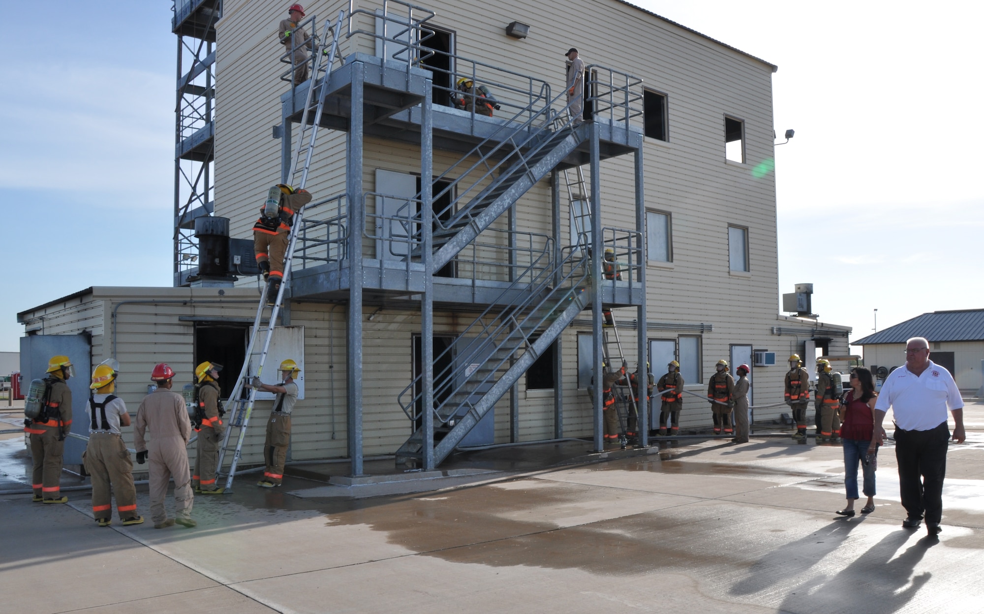 GOODFELLOW AIR FORCE BASE, Texas – Joseph Zapala, 312th Training Squadron Facilities Manager, guides Suzanna Aguirre, San Angelo Chamber of Commerce, on a tour of student fire protection training exercises, July 12.  During the tour, Aguirre witnessed airplane rescue and structure fire training. (U.S. Air Force photo/ Airman 1st Class Joshua Edwards)