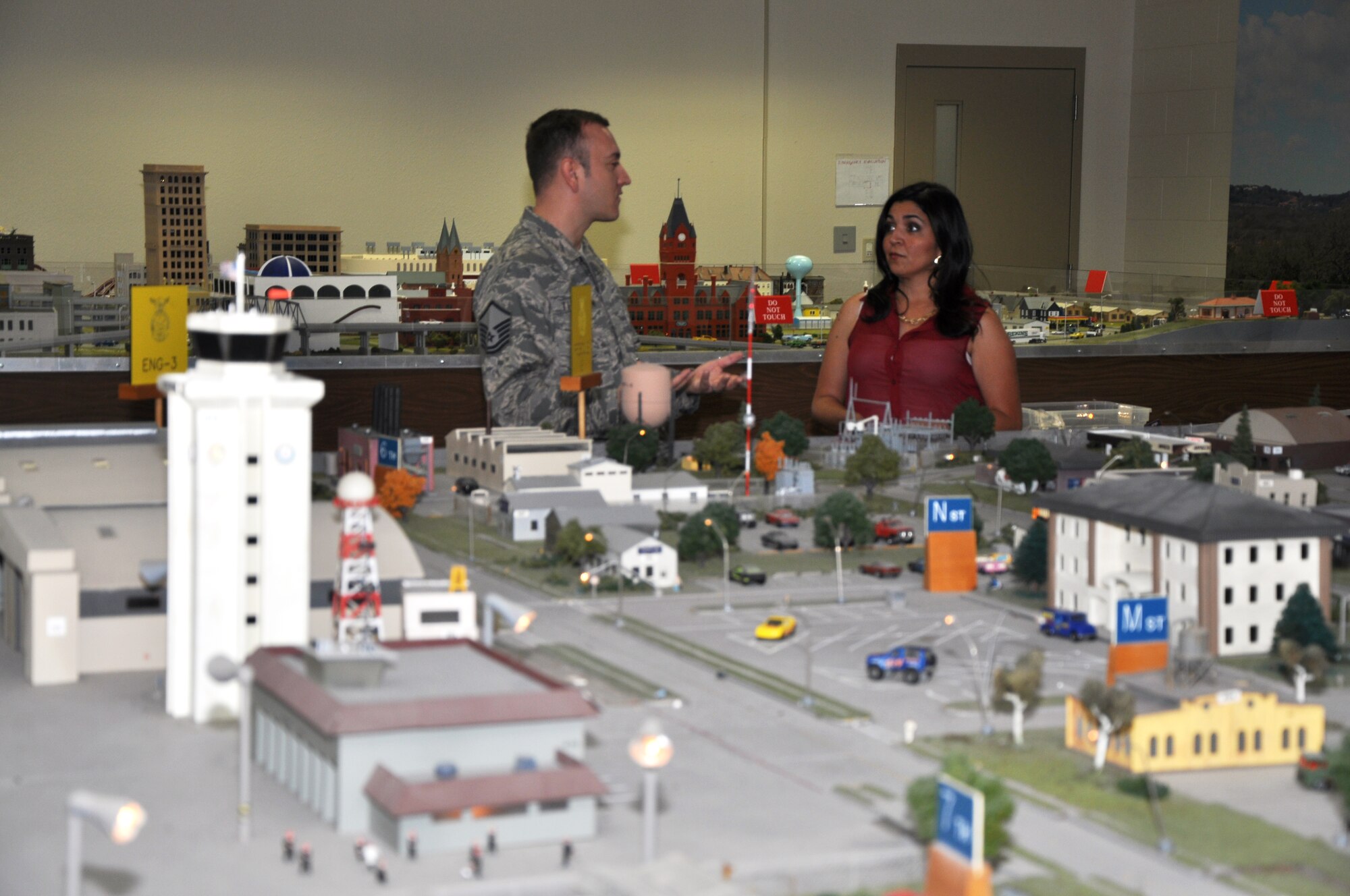 GOODFELLOW AIR FORCE BASE, Texas – Master Sgt. Stephen Thompson, 312th Training Squadron Advanced Course Noncommissioned Officer in Charge, demonstrates to Suzanna Aguirre, San Angelo Chamber of Commerce, how the Norma Brown trainer scale model village works and how it’s used for fire protection training, July 12.  Aguirre visited Goodfellow as a representative of the San Angelo Convention and Visitors Bureau.  (U.S. Air Force photo/ Airman 1st Class Joshua Edwards)